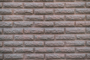 Geometric pattern on the wall in the shape of an old brick	