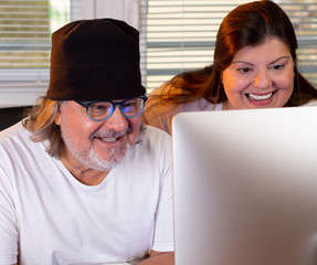 Couple of professionals working together. They are looking at the monitor. They seem enjoying a lot...
