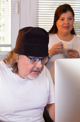 Couple of professionals working together. They are looking at the monitor. She is supervising his...