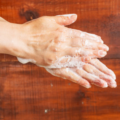Fototapeta premium A woman washes her hands with soap. Hygiene Against Viruses