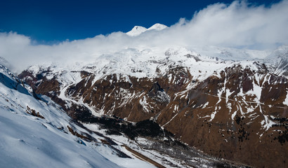 Caucasus mountains winter view with Mount Elbrus on the back and Baksan Valley on the front.