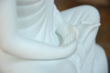 The blurred hand of the white buddha