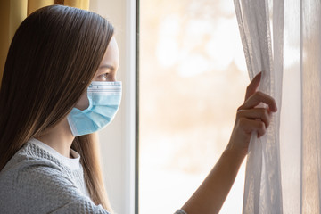 Concept of coronavirus quarantine. Child wearing medical protective face mask during flu virus,...
