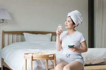 Young asian girls use cell phones in bed