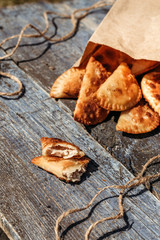 Deep fried pasties wooden background. Rustic style. Natural homemade food.