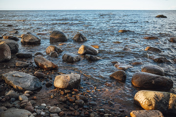 The rocky coast of Baltic sea druring sunny evening time.