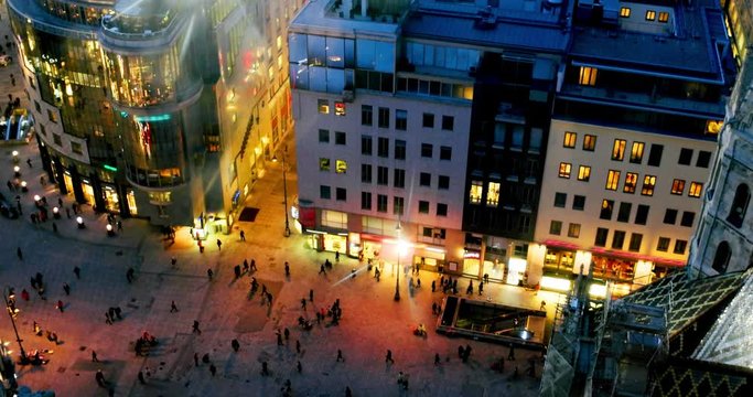 Vienna, Austria. A crowd of people at the Stephansplatz. Aerial night view of the famous landmark with many shops, restaurants, bars, and modern buildings