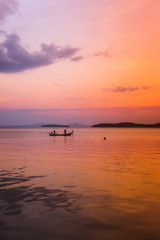 Thai fisherman's boat by an orange sunset