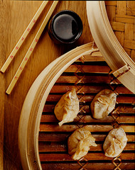 Dim Sum on a steaming pot With Chinese sticks and soy sauce