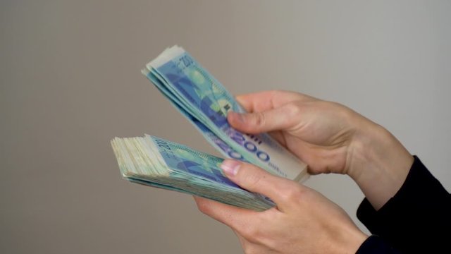A man gives another man money, Israeli shekels