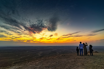 Tourist family on Edge of the World, a natural landmark and popular tourist destination near Riyadh -Saudi Arabia 26-Dec-2019 (Selective focus on the subject and background blurred).
