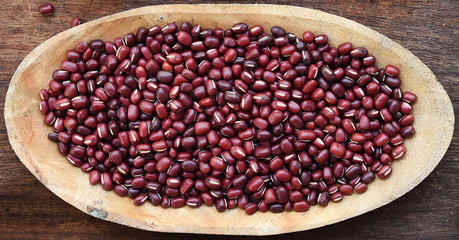 close up of red beans on wooden background