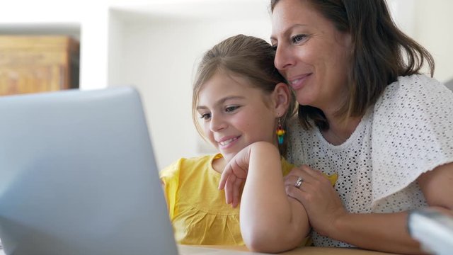 Mother and daughter doing homework online