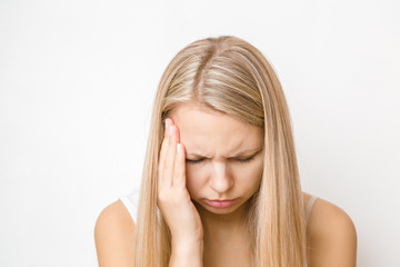 Young, adult blonde lady trying to calm down. Lonely, nervous woman touching head. Memory disorder....