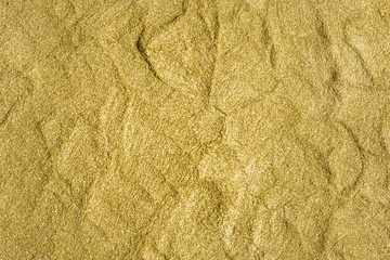 Detailed texture of glittering golden dust surface. Golden Shiny Wallpaper , Perfect for Christmas, New Year or any other Holidays Background. Golden fine powder