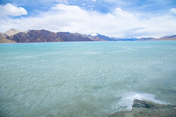 View landscape of Himalayas mountains and Frozen lake Pangong Tso high grassland lake while winter season for indian and tibetan and foreigner travelers travel visit at Leh Ladakh, India.