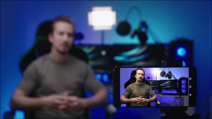 Computer influencer recording video with smartphone template 4K