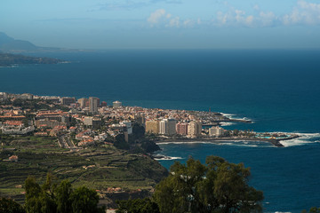 Aerial view of Puerto de la Cruz - Tourist city in Tenerife, Canary islands, Spain. The Atlantic ocean, the coast and mountains in the background. 