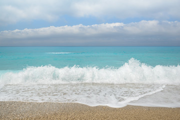 Fototapeta na wymiar Beautiful blue sea with fluffy clouds and beach seascape. Gialos beach, Lefkada island, Greece.