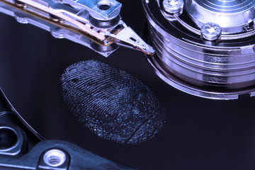fingerprint on a hard drive close up in blue light