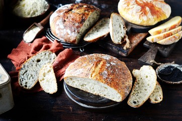 Homemade bread: corn, with sesame seeds and chia seeds on a dark wooden background. rustic
