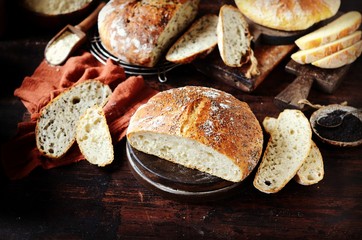 Homemade bread: corn, with sesame seeds and chia seeds on a dark wooden background. rustic

