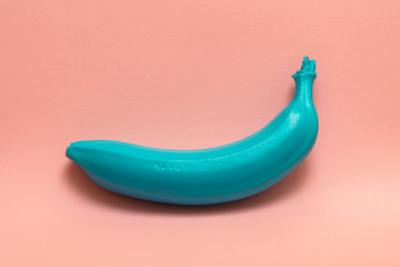 cyan colored banana on pink background.pop art 