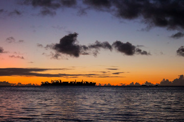 Fototapeta na wymiar sunset seascape epic clouds with ship in saipan