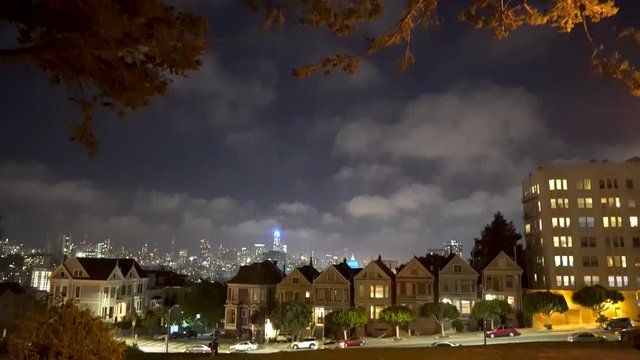 Painted Ladies in San Francisco California at Night time with city skyline in the background