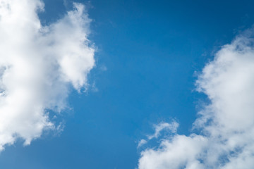Obraz premium Background nature clear clean blue sky soft clouds beautiful dramatic cloudscape summer sun ray light presents beautiful day life after storm. use as overlay effect or frame with center copy space 