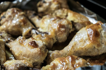 Golden chicken legs in batter fried in a pan