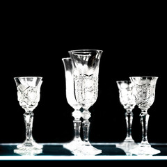 Set of crystal glasses and carafe on a dark background
