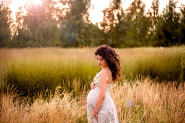young  pregnant woman in a field