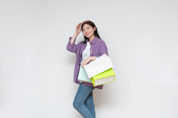 A young asian woman with a shopping bag in her hand