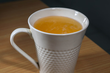 macro photo cup of syrup orange or vitamin C