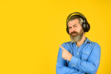 bearded man hipster pointing finger, copy spce. listen audio book. Music beat for energetic mood....
