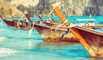Fototapeta na wymiar Longtail boats moored on the banks of Krabi - Popular tourist attraction in Thailand - Wanderlust style travel concept - Place of embarkation and disembarkation of tourists