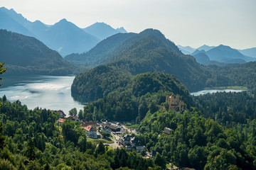 Panoramic view of the Schwangau village in the Alps and a beautiful yellow castle. Photograph taken in Schwangau, Bavaria, Germany.