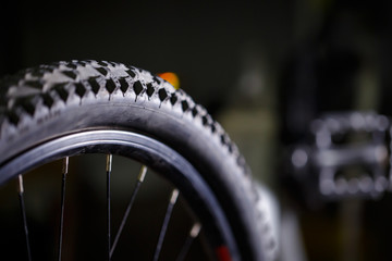 Black rubber tire with spikes for a bicycle wheel. Bike accessories