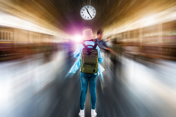 Young solo woman backpacker tourist wait depart time clock to summer adventure voyage journey at...