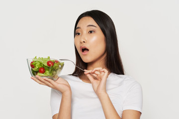 young woman holding a bowl of salad