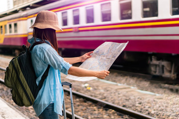 Fototapeta premium Solo backpacker traveler plan safety trip low cost budget summer holiday after coronavirus crisis. Empty tourist on train railway platform. Use bus train sustainable environmental friendly transport