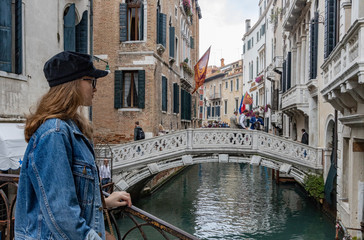 girl standing on a bridge in venice italy