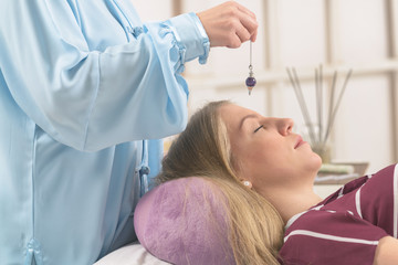 Therapist using pendulum