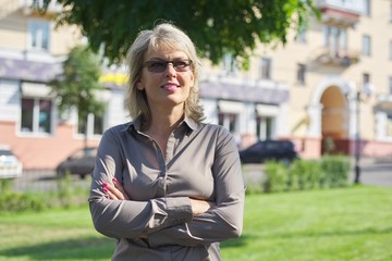 Portrait of mature business confident woman with folded arms