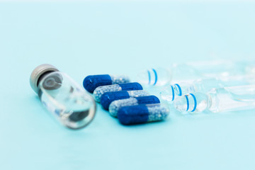 injection ampoules for vaccination on a blue background, healthcare coronavirus, cancer, painand treatment, pharmaceutical medicine concept .