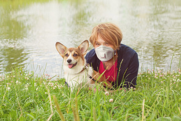 Happy older woman in medical mask and her dog outdoors (woman 60 years old)