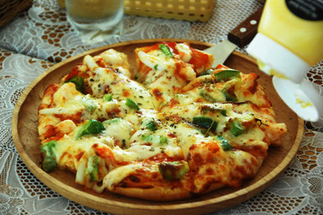 Italian Pizza with seafood and mozzarella cheese on wooden cutting board