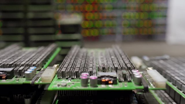 ASIC electrical circuit boards with radiators in repair service center. Cryptocurrency mining equipment at large farm with blinking lights on background. Bitcoin miners component parts for replacement