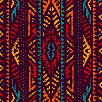 Seamless ethnic ornament. Aztec and tribal motifs. Ornament drawn by hand. Blue, purple, yellow, red and orange colors. Print for your textiles. Vector illustration.